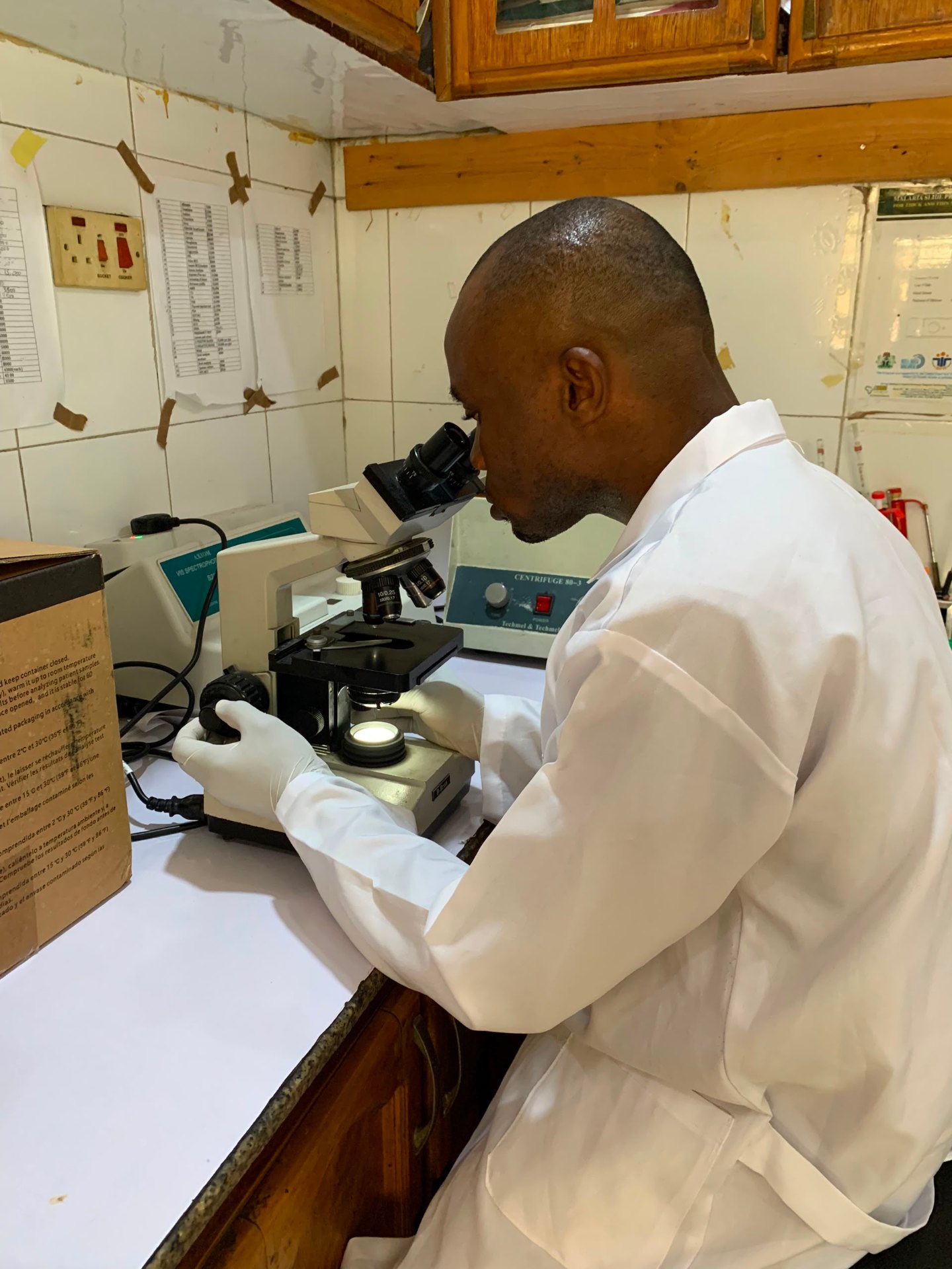 Laboratory scientist using a microscope at Prestige Specialist Hospital